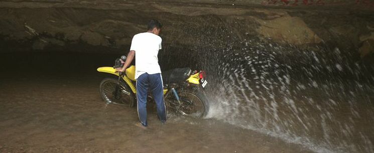 Washing the bike in Gua Ikan